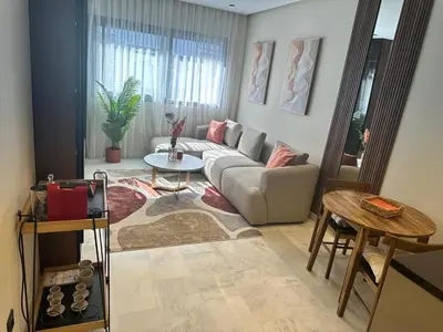 a living room with a couch and a table at Harmonie Elitaire in Casablanca