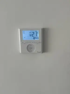 a digital clock on a white wall at Appart idéal Face Gare Agdal in Rabat