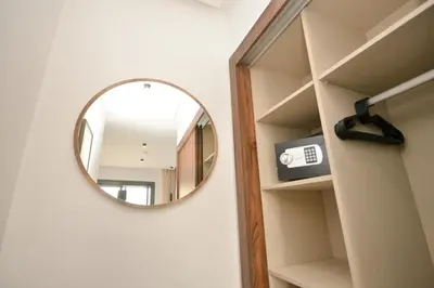 a round mirror on a wall in a room at Antonio Cerezo in Maarif