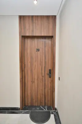 a wooden door with a mat in front of it at Antonio Cerezo in Maarif
