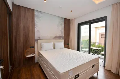 a bedroom with a bed and a large window at Antonio Cerezo in Maarif