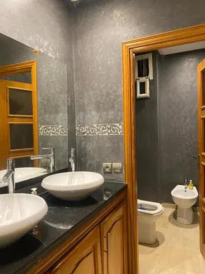 a bathroom with two sinks and a toilet at coastal charm harhoura in Temara
