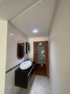 a bathroom with a sink and a toilet at coastal charm harhoura in Temara
