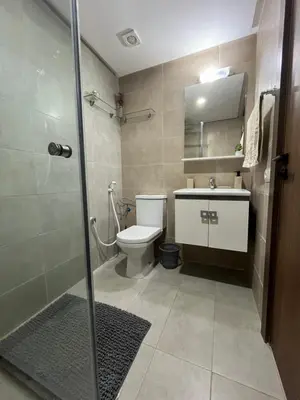 a bathroom with a toilet and a sink and a shower at Appartement cosy et confortable in Casablanca