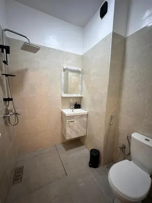 a bathroom with a toilet and a sink and a shower at Appartement de luxe 2 chambres PS5,AC,Fibre,Netflix à agdal Au coeur de Rabat in Rabat