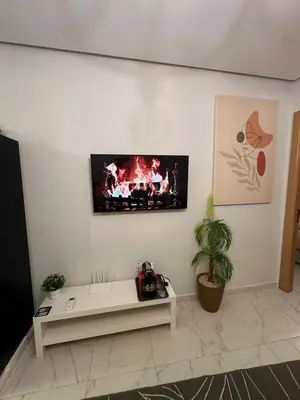 a living room with a tv on the wall at Chic Studio In The Heart of Casablanca Morocco in Casablanca