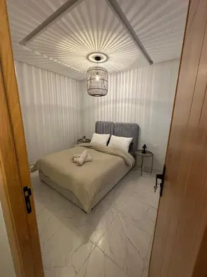 a bedroom with a bed and a chandelier at Chic Studio In The Heart of Casablanca Morocco in Casablanca