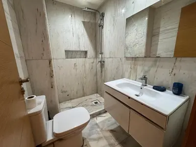 a bathroom with a white toilet and a sink at Modern studio with large terrace and parking in Casablanca