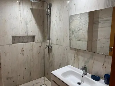 a bathroom with a sink and a mirror at Modern studio with large terrace and parking in Casablanca