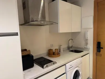 a small kitchen with a sink and a microwave at Modern studio with large terrace and parking in Casablanca
