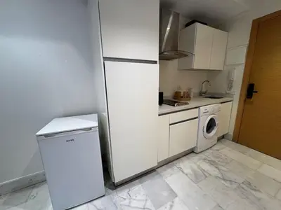 a kitchen with a refrigerator and a washing machine at Modern studio with large terrace and parking in Casablanca
