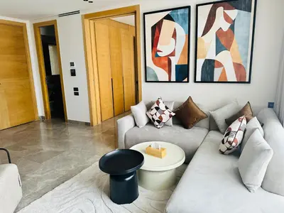 a living room with a couch and a table at Premium Stay - Opale Seaside Beachfront in Anfa-Supérieur