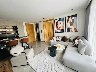 a living room with a couch and a table at Premium Stay - Opale Seaside Beachfront in Anfa-Supérieur