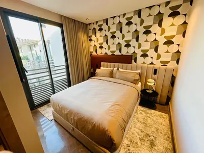 a bedroom with a large bed and a large window at Premium Stay - Opale Seaside Beachfront in Anfa-Supérieur