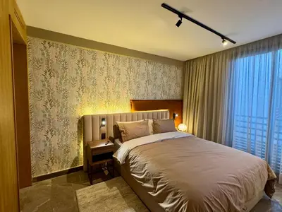 a bedroom with a bed and a large window at Premium Stay - Opale Seaside Beachfront in Anfa-Supérieur