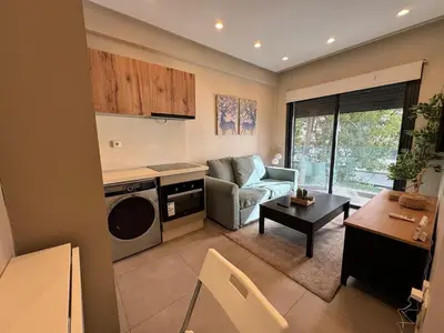 a kitchen and living room with a couch and a table at Studio en plein centre de Gautier in Casablanca