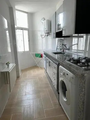 a kitchen with a washer and dryer in it at studio ensoleillé á louer Témara, in Temara