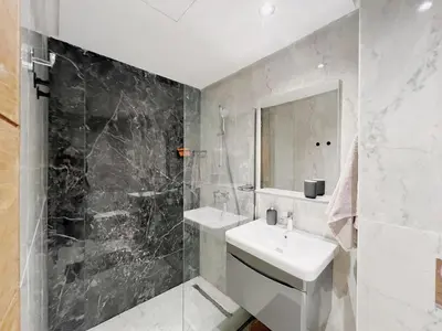 a white bathroom with a sink and a mirror at Cosy Central Appart in Casablanca Best Location in Maarif