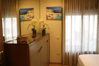 a bedroom with a dresser with flowers on it at Appartement à Gauthier, Casablanca in Casablanca