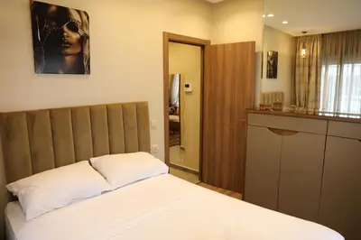 a bedroom with a bed with a wooden headboard at Appartement à Gauthier, Casablanca in Casablanca