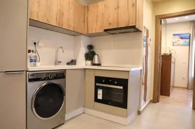 a kitchen with a washing machine and a sink at Appartement à Gauthier, Casablanca in Casablanca