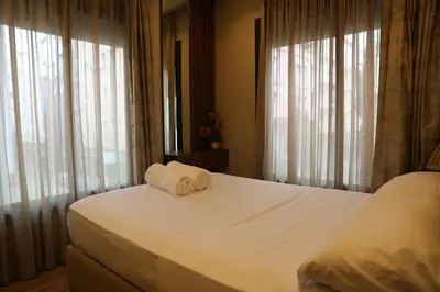 a bedroom with a bed with two towels on it at Appartement à Gauthier, Casablanca in Casablanca