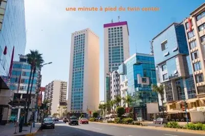 a city street with tall buildings and cars on the road at Appartement à Gauthier, Casablanca in Casablanca