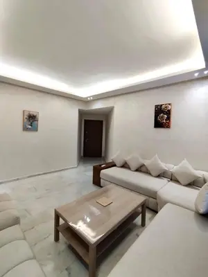 a living room with a couch and a coffee table at Hideaway Rosa Parc Mohammedia in Mohammedia