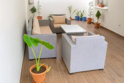 a living room with a couch and a table at Hideaway Rosa Parc Mohammedia in Mohammedia