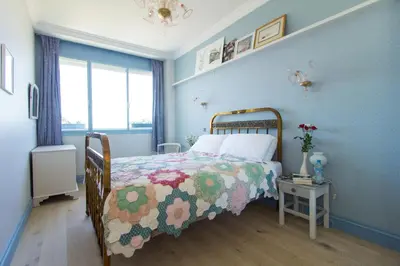 a bedroom with a bed with a colorful quilt on it at Appartement Lilia in Casablanca