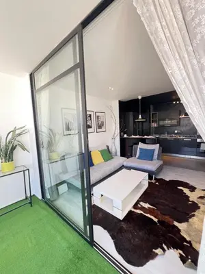 a living room with a couch and a table at Stay IN GAUTHIER studio M in Casablanca