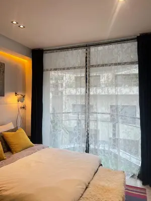 a bedroom with a bed and a large window at Stay In GAUTHIER studio s in Casablanca
