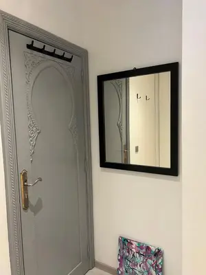 a mirror on a wall next to a door at Stay In GAUTHIER studio s in Casablanca