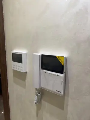 two microwaves are attached to a wall at Studio au parc calme in Mohammedia