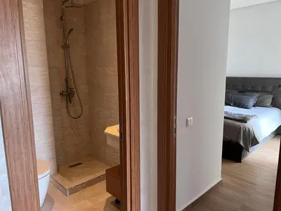 a bathroom with a shower and a bed in a room at Sidi Rahal Blue View 3, front mer, accès plage 1 Piscine in Sidi Rahal
