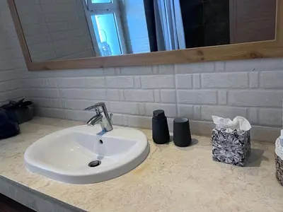 a bathroom counter with a sink and a mirror at Sidi Rahal Blue View 3, front mer, accès plage 1 Piscine in Sidi Rahal