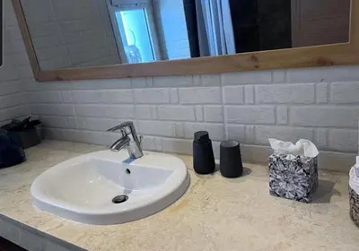 a bathroom counter with a sink and a mirror at Sidi Rahal Blue View 3, front mer, accès plage 1 Piscine in Sidi Rahal