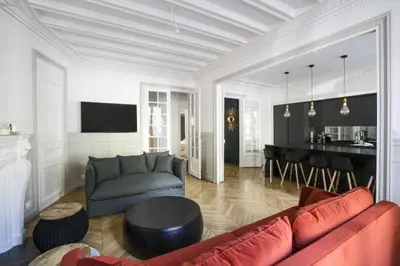 a living room with a red couch and a table at guzman appartement in Sidi Yahia az Zaʼer