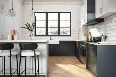 a kitchen with a counter and two bar stools at guzman appartement in Sidi Yahia az Zaʼer