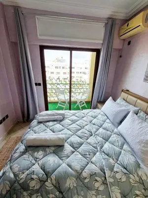 a bedroom with a bed and a large window at appartement central in Casablanca