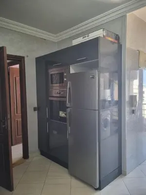 a large stainless steel refrigerator in a kitchen at appartement central in Casablanca