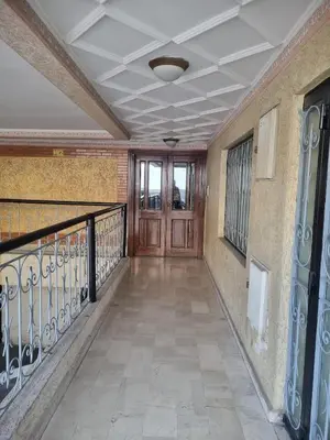 a hallway with a wooden door and a balcony at appartement central in Casablanca