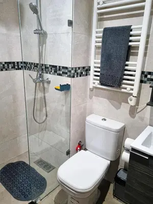 a bathroom with a toilet and a glass shower at appartement central in Casablanca