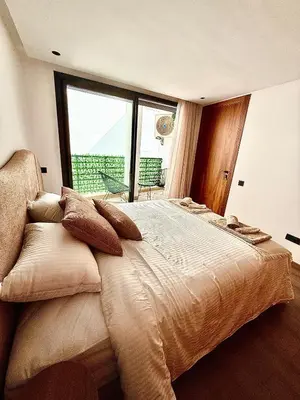 a bedroom with a large bed and a large window at Adresse remarquable casablanca in Casablanca