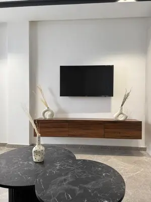 a living room with a tv and a table at Adresse remarquable casablanca in Casablanca