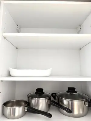 two pots and pans on a shelf in a kitchen at Adresse remarquable casablanca in Casablanca