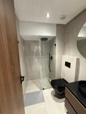 a bathroom with a black toilet and a shower at Adresse remarquable casablanca in Casablanca