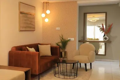 a living room with a couch and a chair at Appartement Bouznika in Bouznika