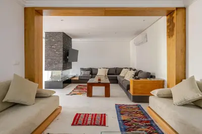 a living room with a couch and a table at Villa Evasion Rabat Beach in Rabat