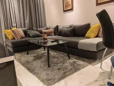 a living room with a couch and a glass table at studio casa in Casablanca